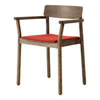 "Natural wood armchair with a vibrant red seat cushion, featuring a sleek and modern design."