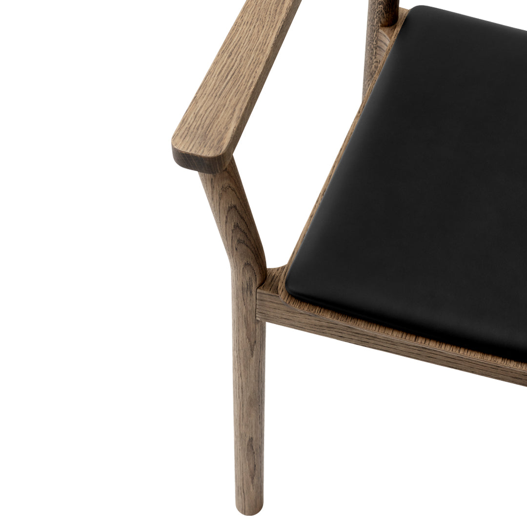 Black leather seat with a natural wood frame, showcasing a sleek, minimalist design.