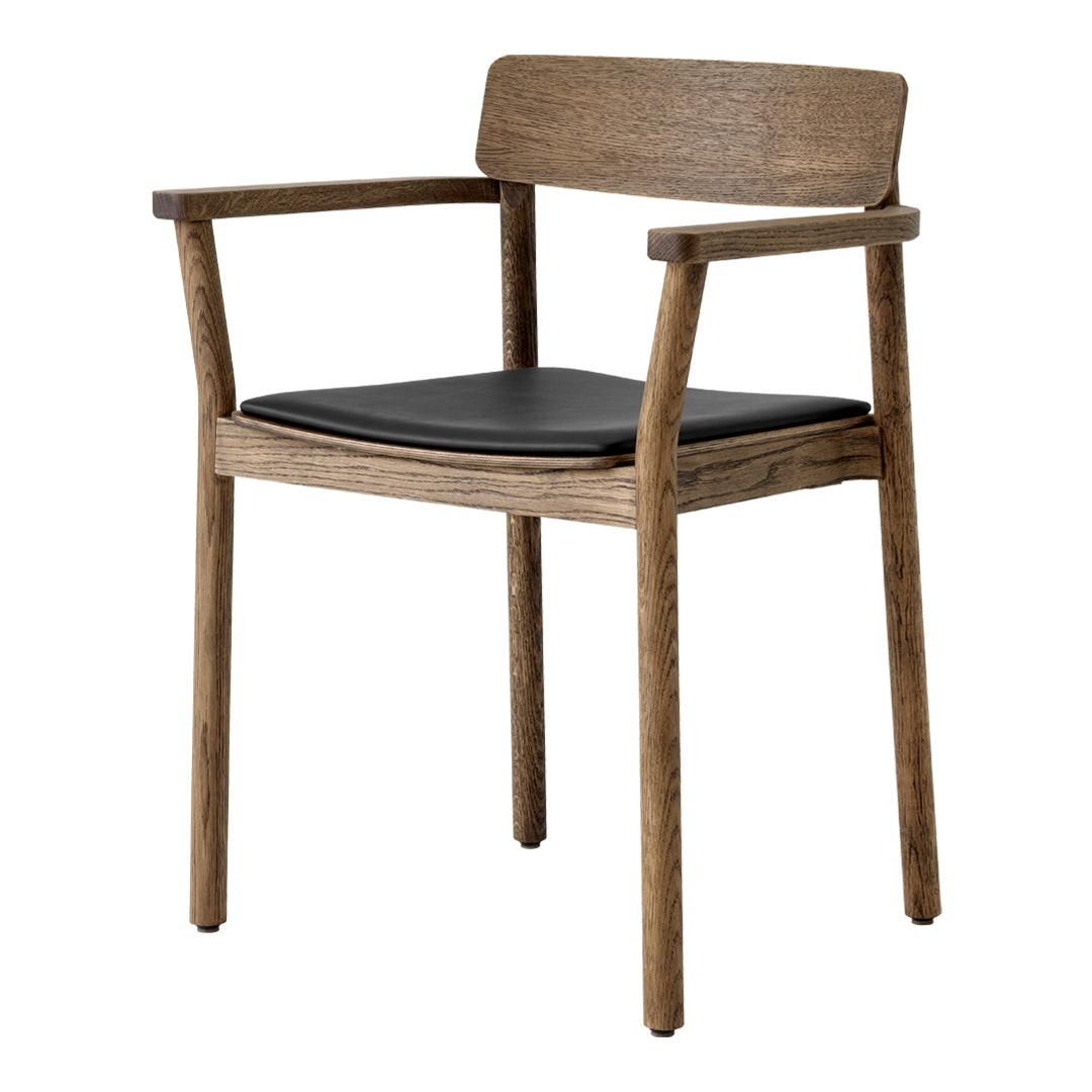 Wooden chair with a natural finish and sleek black leather seat, featuring a simple, modern design.