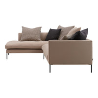 Beige sectional sofa with textured brown and black accent pillows, modern design and sleek metal legs.