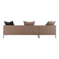 Modern beige sofa with solid lines and black, light brown, and taupe accent pillows. Elegant minimalist design.