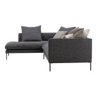 Dark gray sectional sofa with assorted beige and gray throw pillows, featuring a sleek modern design and minimal patterns.