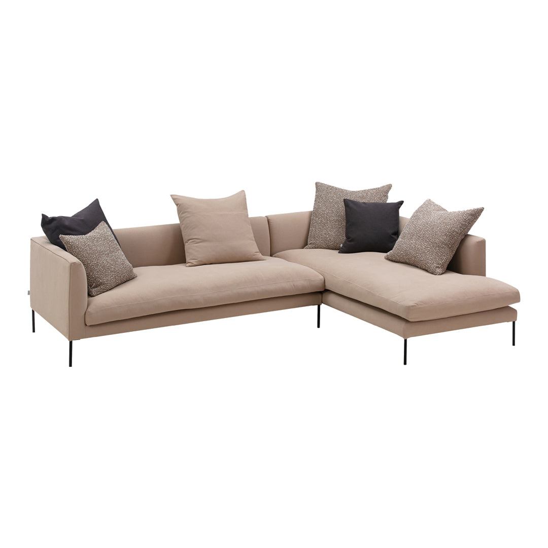 Beige sectional sofa with gray and black cushions, featuring a sleek, modern design and minimalist patterns.