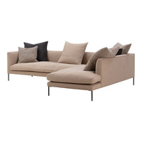 Beige sectional sofa with varied textured black and cream pillows, featuring a modern, minimalist design.