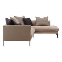 Beige sectional sofa with textured pillows in dark gray, light beige, and patterned fabric. Modern minimalist design.