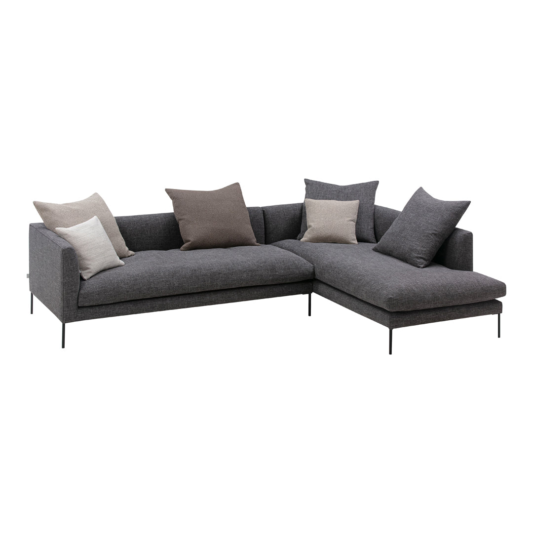 Gray sectional sofa featuring a mix of smooth and textured fabrics with light and dark neutral pillows.