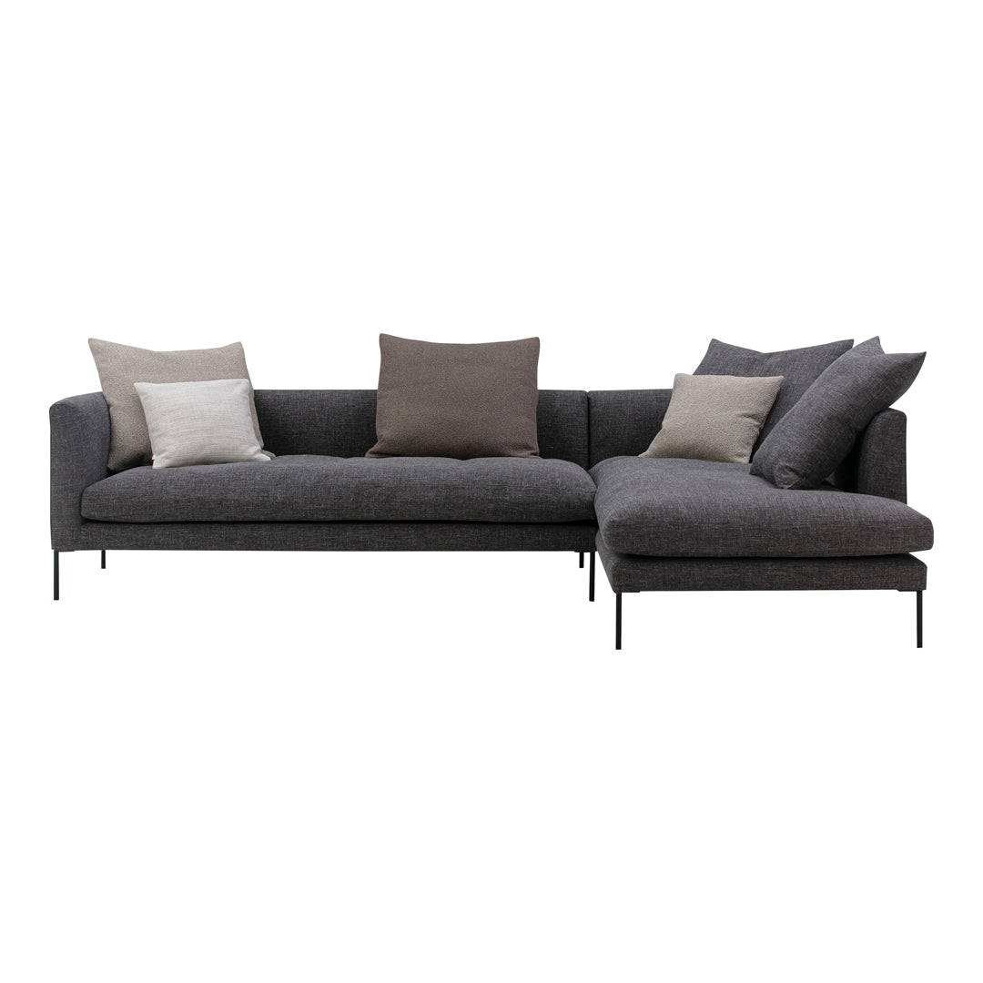 "Modern gray sectional sofa with mixed beige and gray decorative pillows, featuring clean lines and a minimalist design."