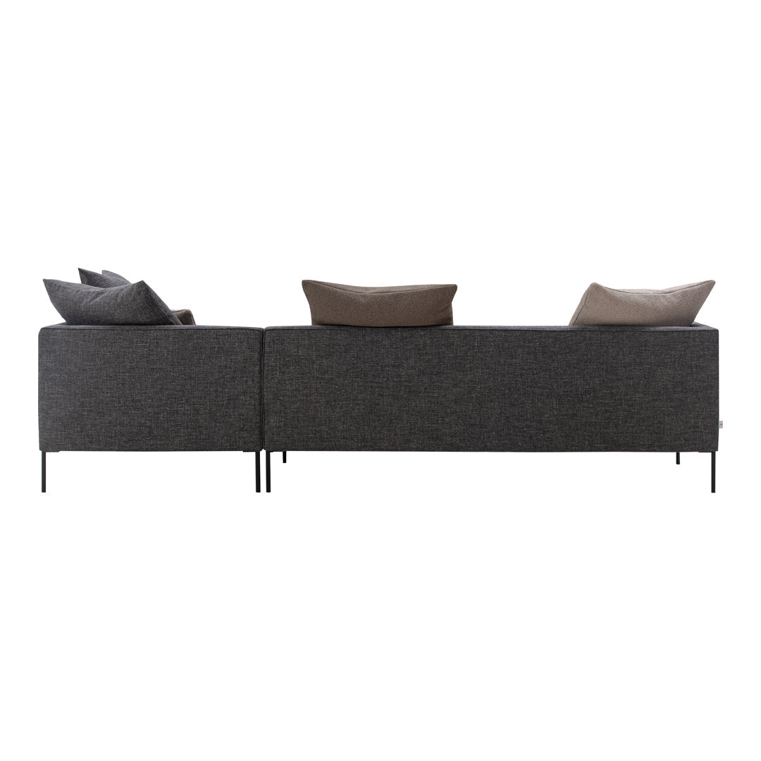 Gray upholstered sofa with dark gray and brown accent pillows, featuring a sleek, modern design.