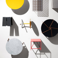 Colorful assortment of round and square tables in yellow, black, pink, gray, and white, featuring various modern patterns.