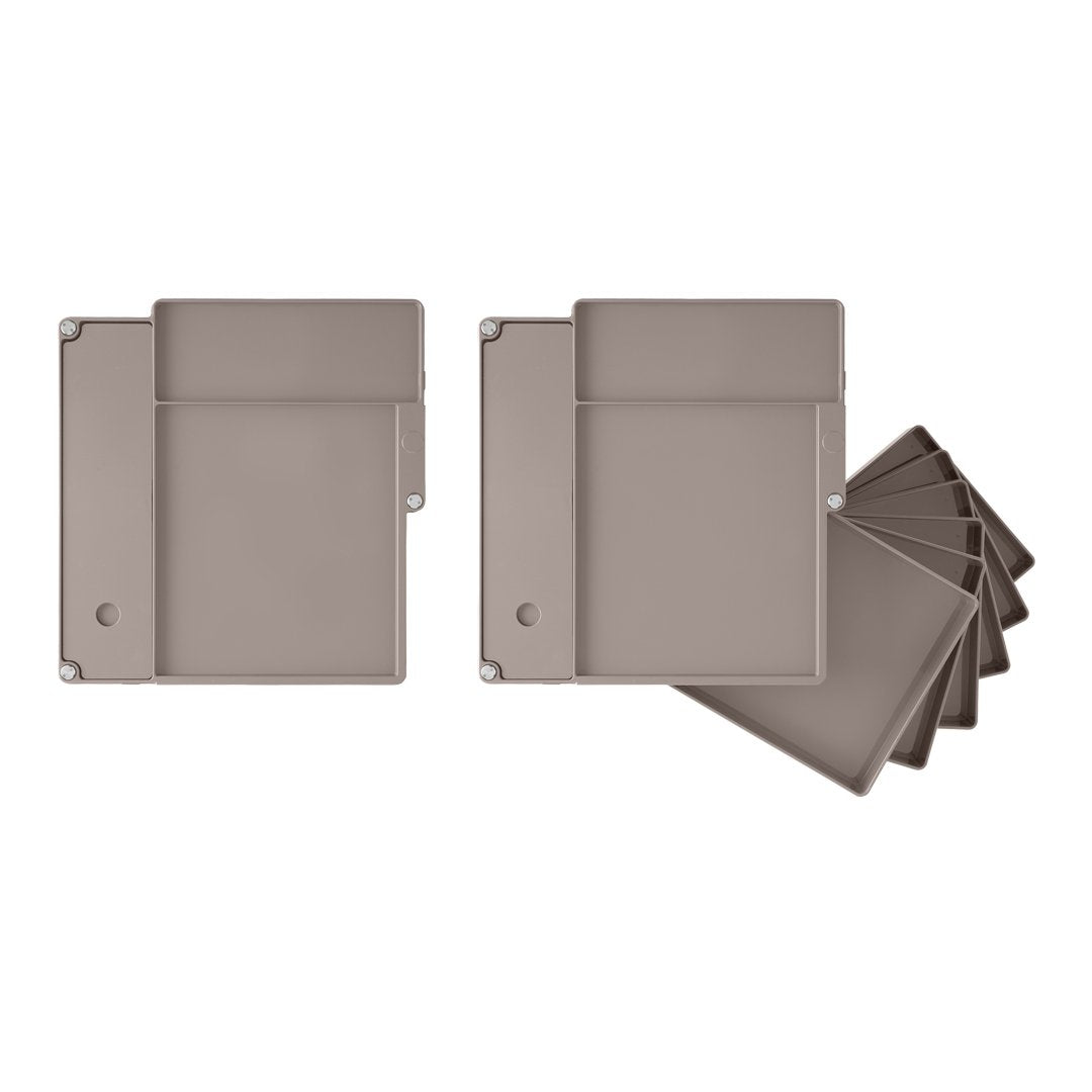 Set of gray, smooth storage containers with a minimalist design and subtle matte finish, showcasing simple geometric shapes.