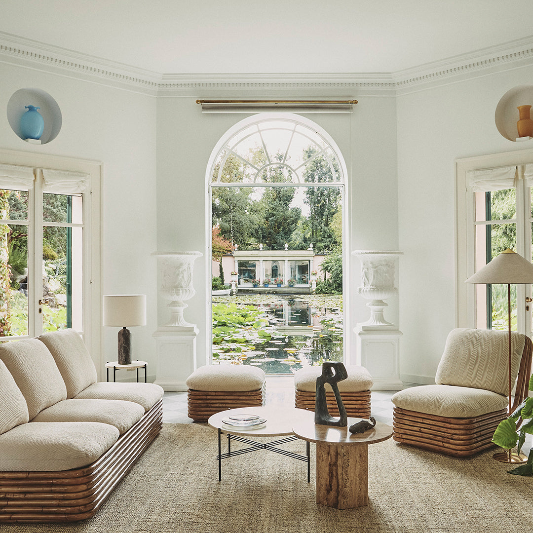 Cozy living room featuring a neutral palette with beige furniture and natural textures, accented by soft blue and green decor.
