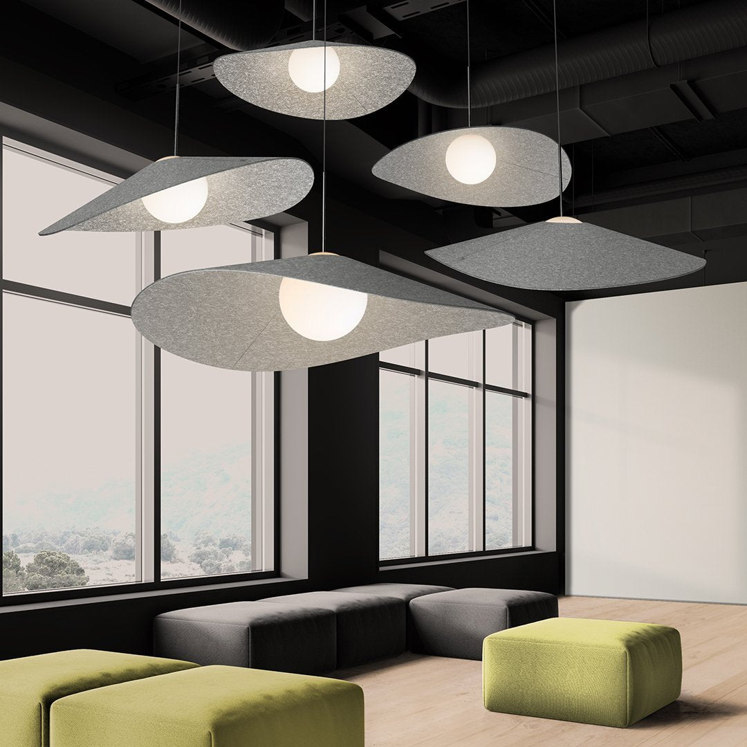 Modern gray pendant lights with soft curves, illuminating a sleek, contemporary space with green and neutral tones.