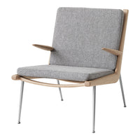 Gray upholstered chair with natural wood frame and silver metal legs, showcasing a minimalist design.
