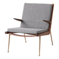 Gray fabric armchair with a clean, modern design and wood accents, featuring simple, elegant lines.