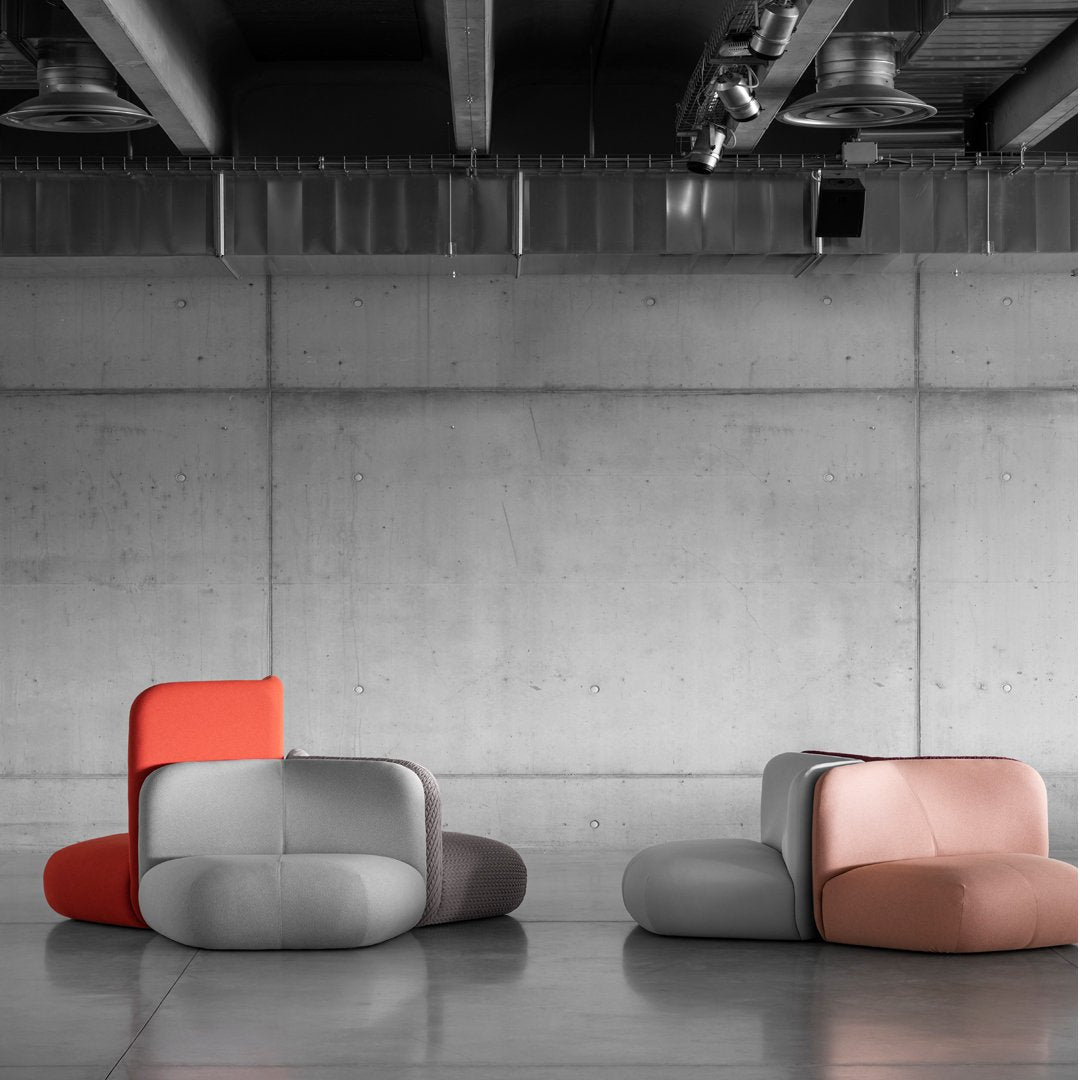 Modern, minimalist sofas featuring soft gray, coral, and peach hues with smooth, contemporary shapes.