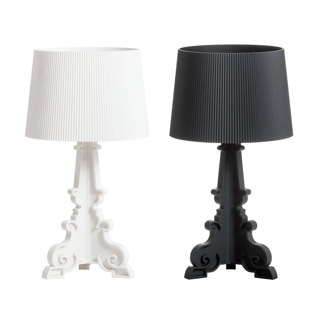 "Elegant white and black ribbed lamps with ornate bases, perfect for modern or classic decor."
