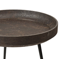 Round metal tray table with a distressed dark brown finish and a smooth surface, featuring sturdy black legs.