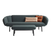 Teal sofa with rounded arms, featuring two textured cushions in burnt orange and subtle cream stripes on a matching ottoman.