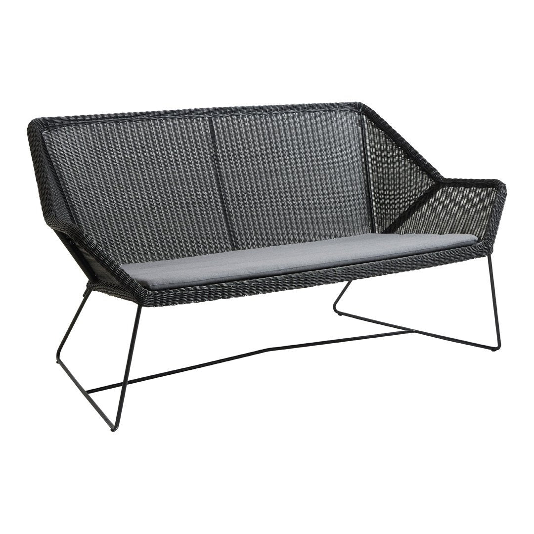 Stylish black wicker loveseat with grey cushions and modern wireframe legs, perfect for outdoor or indoor decor.