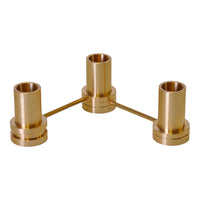 Brass candle holder with a shiny, gold finish and sleek, modern design featuring three cylindrical holders.