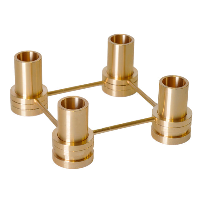 "Elegant gold candle holder with a sleek, modern design and polished finish, featuring symmetrical cylindrical shapes."