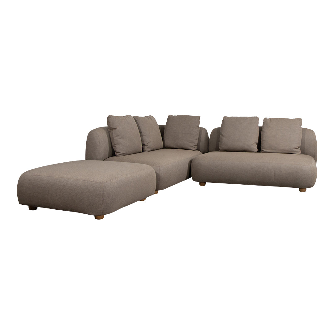 Light gray sectional sofa with plush cushions and smooth upholstery. Minimalist design with rounded edges and wooden legs.