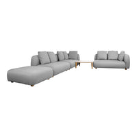 Modular sectional sofa in soft gray fabric with clean lines and plush cushions, accentuated by light wooden legs.