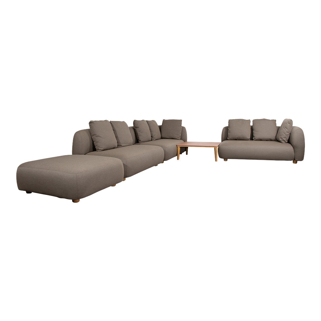 "Soft gray sectional sofa with a minimalist design and plush cushions, perfect for modern living spaces."
