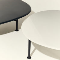 Minimalist black and white coffee tables with smooth finishes and sleek black legs, perfect for modern decor.