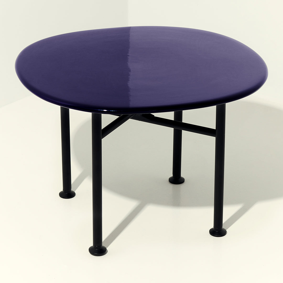 Purple round table with a glossy finish and black metal legs, perfect for modern decor.