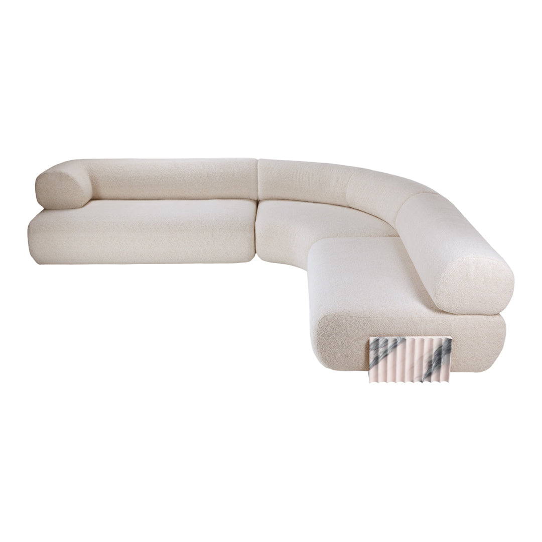 Curved beige sofa with textured upholstery and subtle neutral patterns for a modern, stylish look.