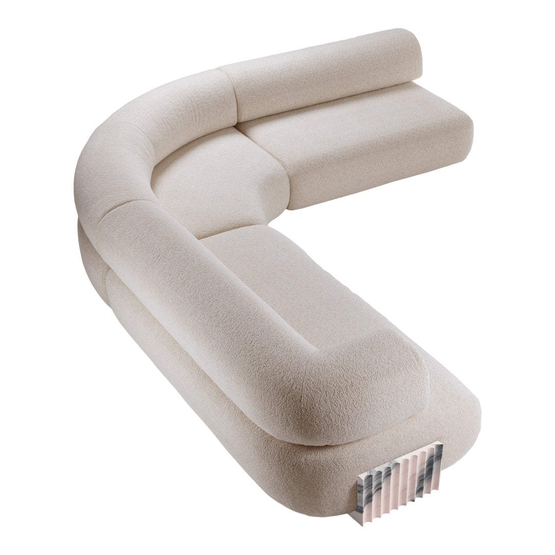 Curved beige sofa with a soft, textured fabric and a subtle, modern design, ideal for contemporary interiors.
