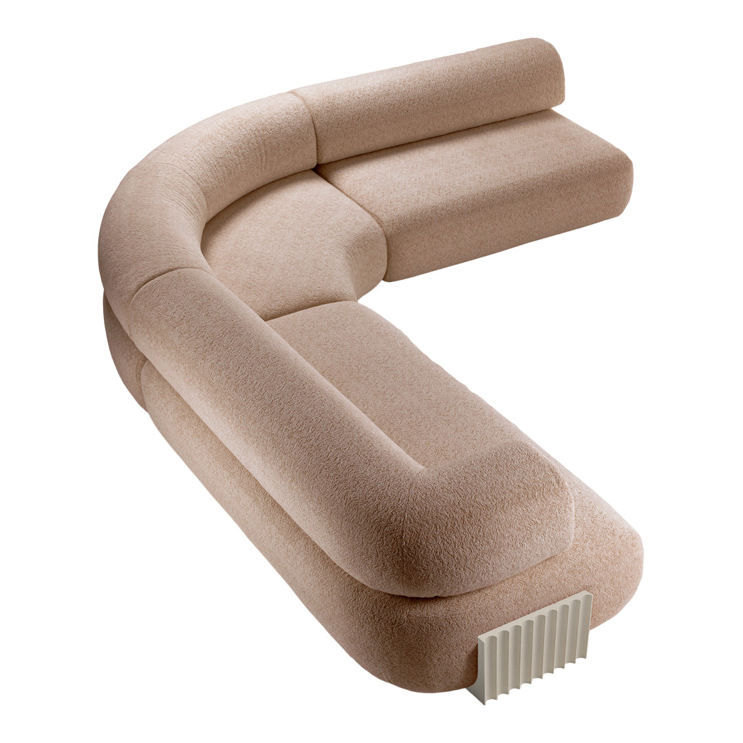 Curved sofa in a soft beige texture, featuring a minimalist design with subtle patterns and smooth, rounded edges.