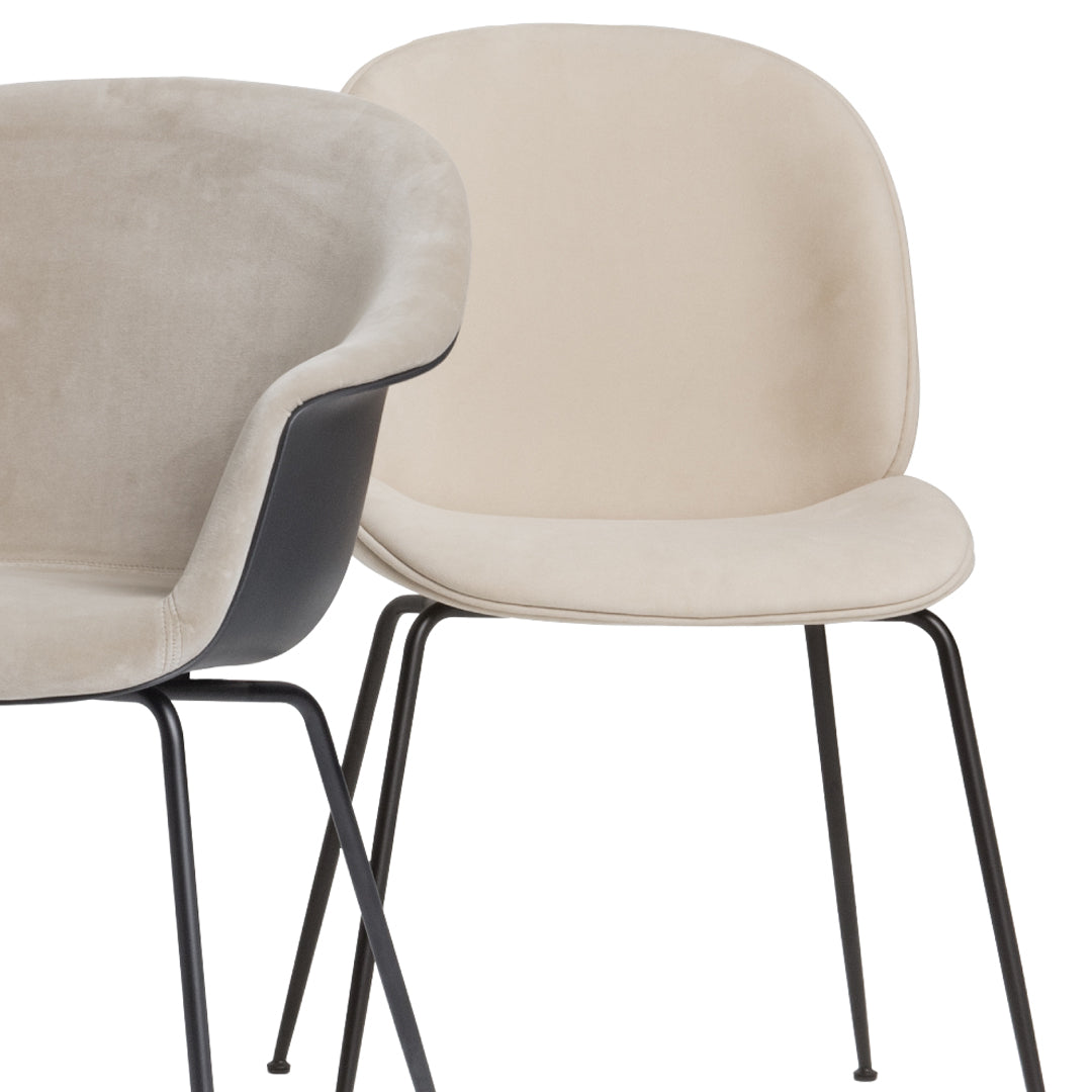Beige and gray upholstered chairs with smooth curves and sleek black metal legs. Modern and minimalist design.