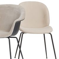 Beige and gray upholstered chairs with smooth curves and sleek black metal legs. Modern and minimalist design.