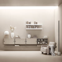 Modern minimalist living room scene featuring beige tones, white shelving, and subtle textures.