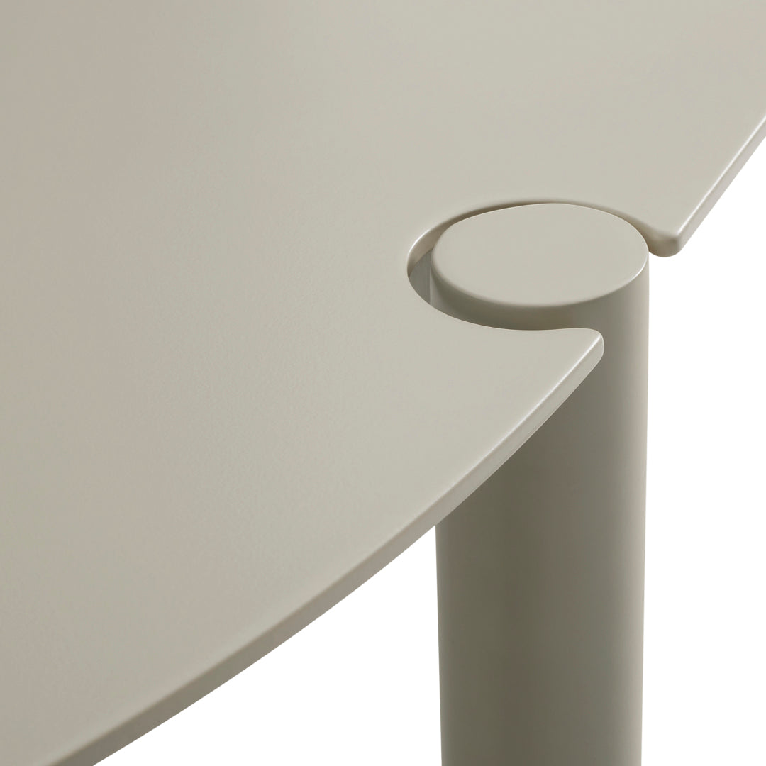 Light beige table surface with smooth curves and a circular joint detail, perfect for modern decor.