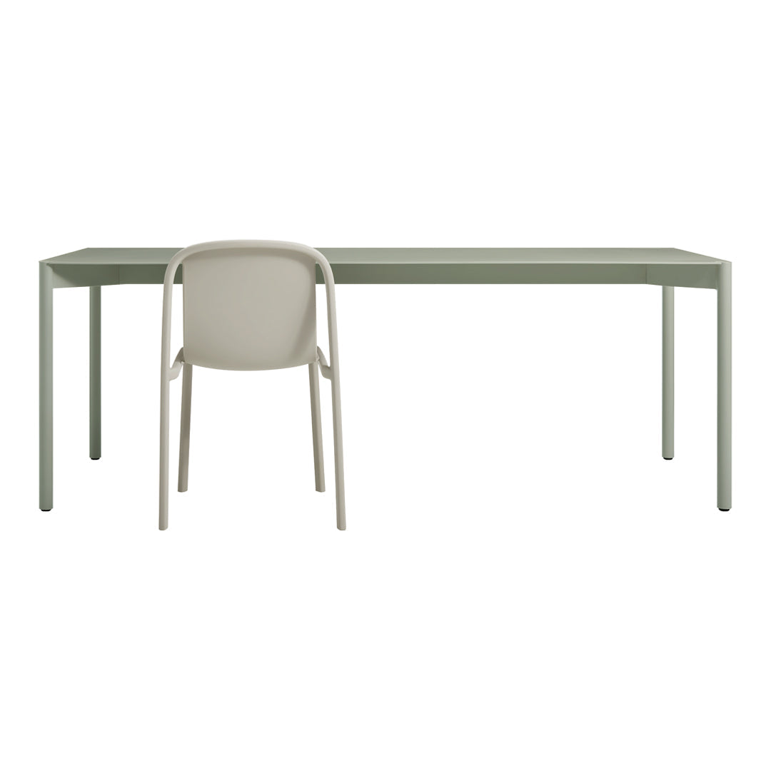 Minimalist green desk paired with a light beige chair, showcasing a modern, sleek design.