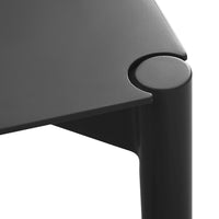 Sleek black table with smooth finish and rounded corner detail, showcasing minimalist design and modern aesthetic.