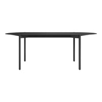 Black dining table with a sleek, modern design and smooth surface. Minimalist style complements various decor.