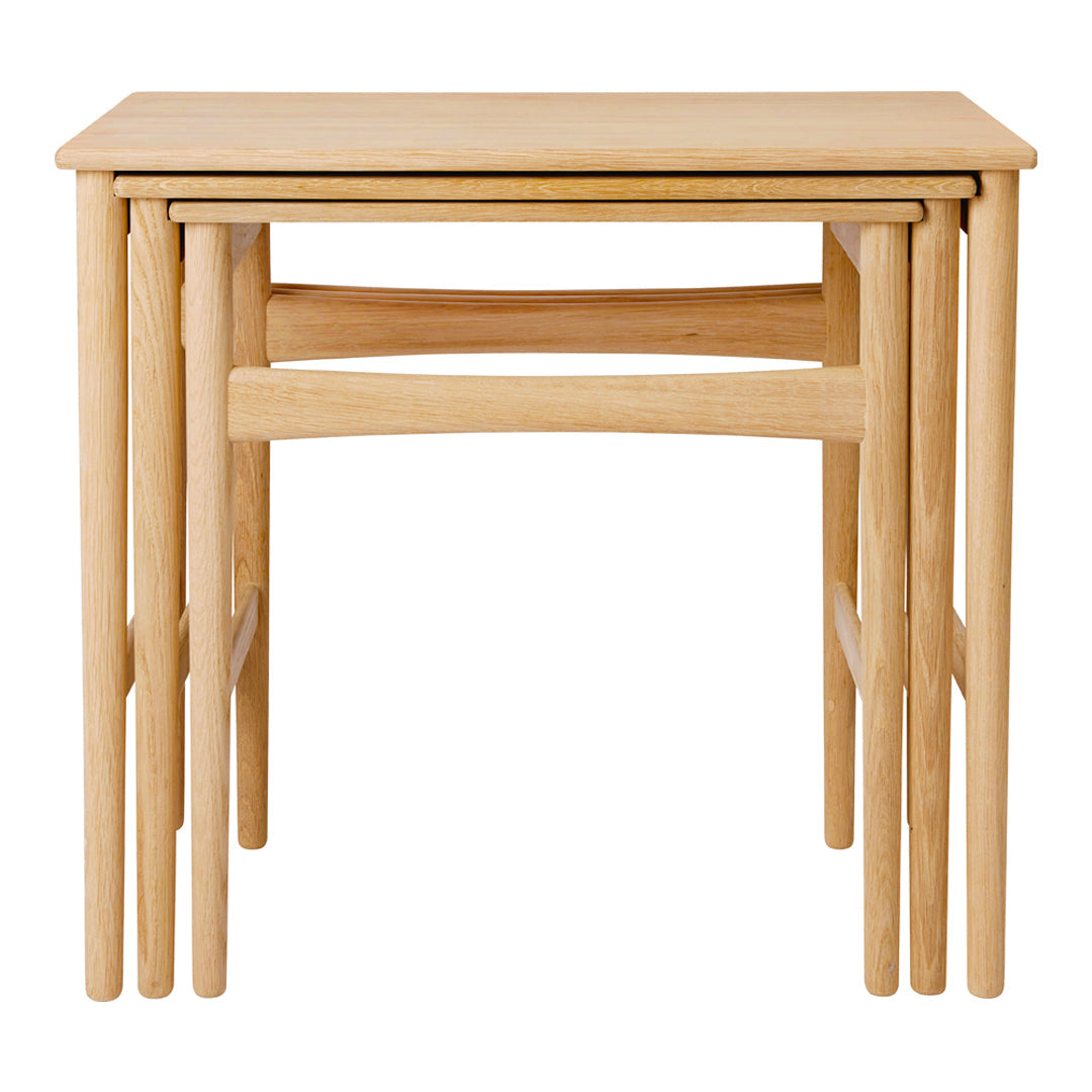 Natural wood nesting tables with a smooth finish and simple, modern design. Ideal for versatile home décor.