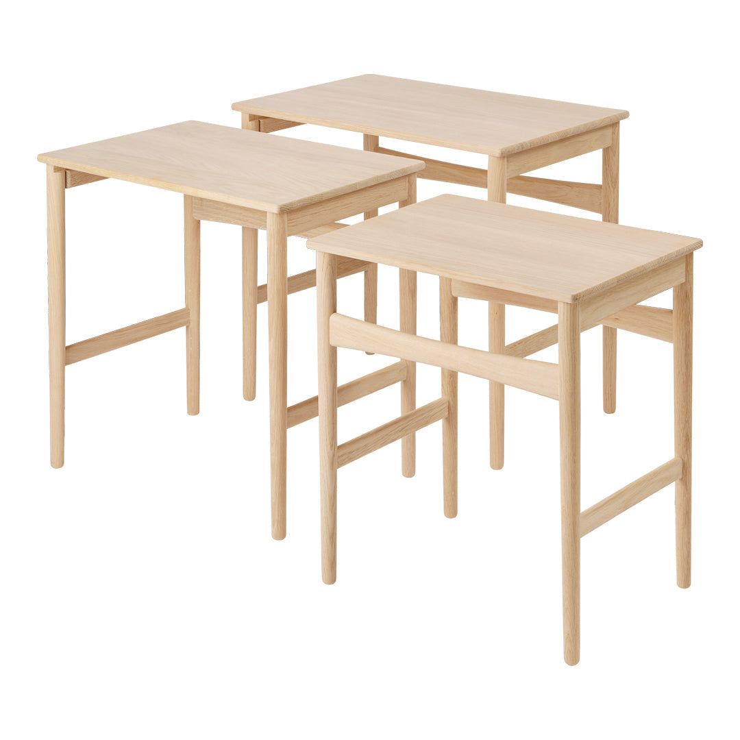 Natural wood finish nesting tables with a light, simplistic design. No patterns; versatile for any decor style.