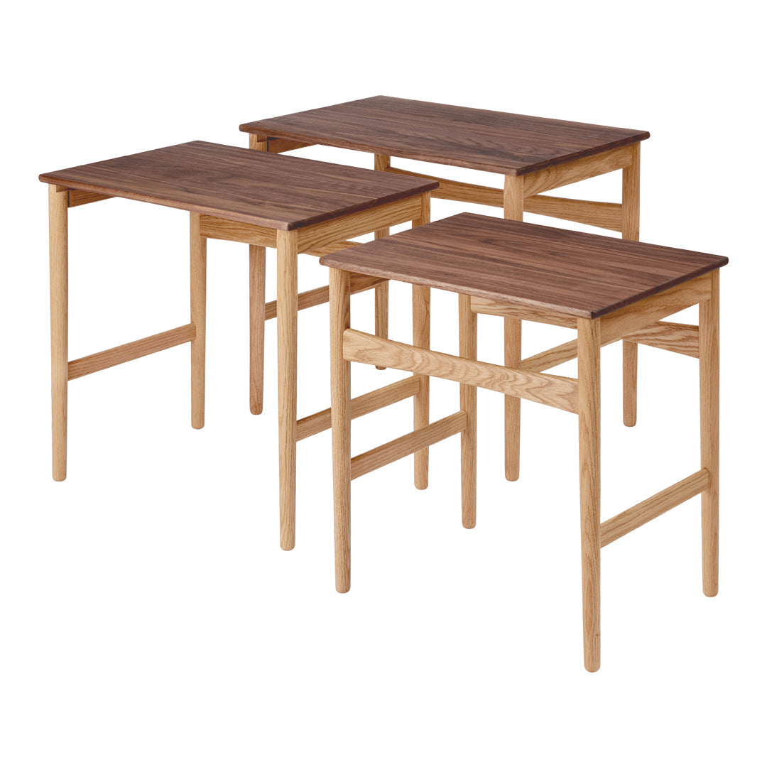 Set of three wooden side tables with a natural finish and dark walnut tabletops, featuring simple, clean lines.