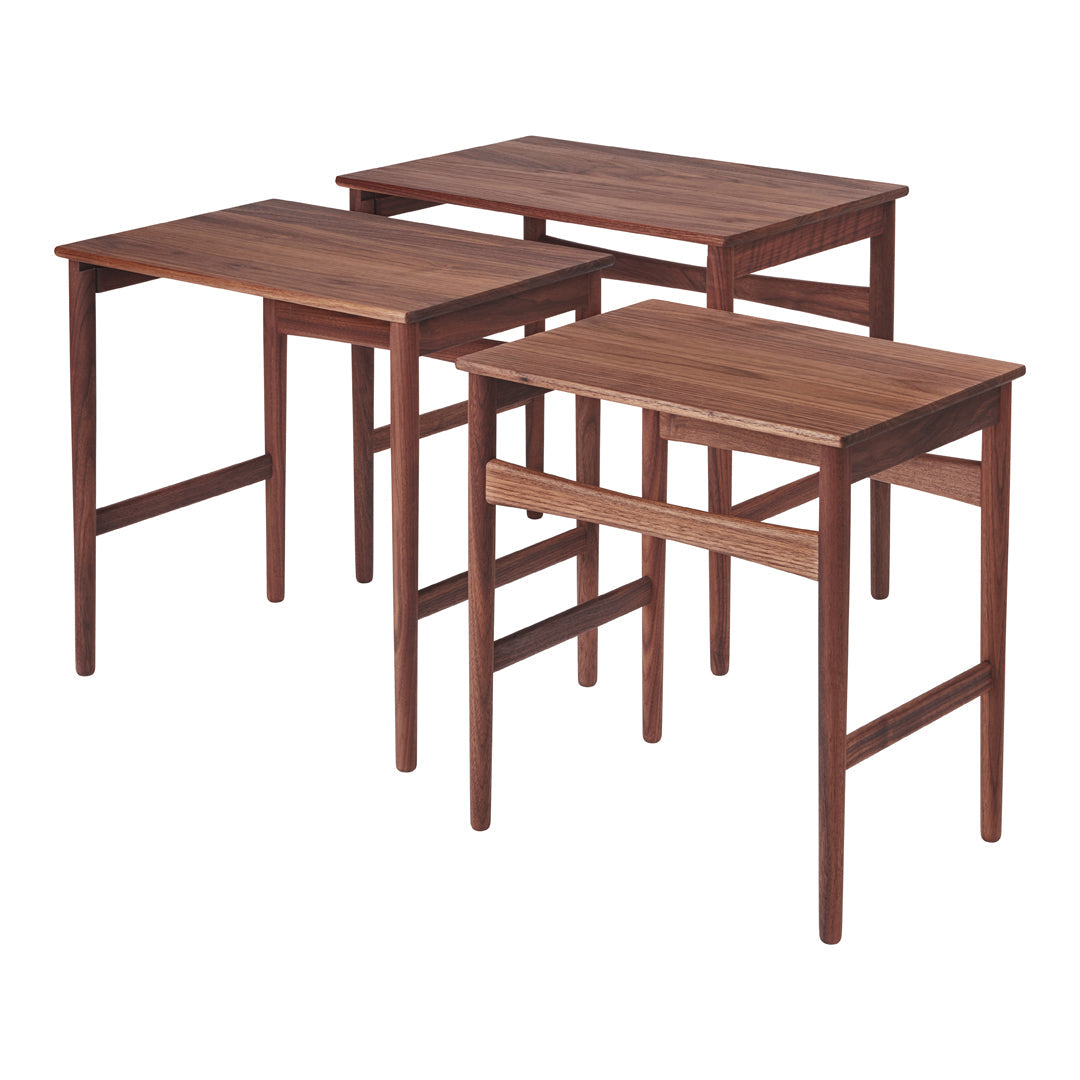 Set of three wooden tables in rich walnut finish with a smooth, sleek design. Perfect for modern decor.