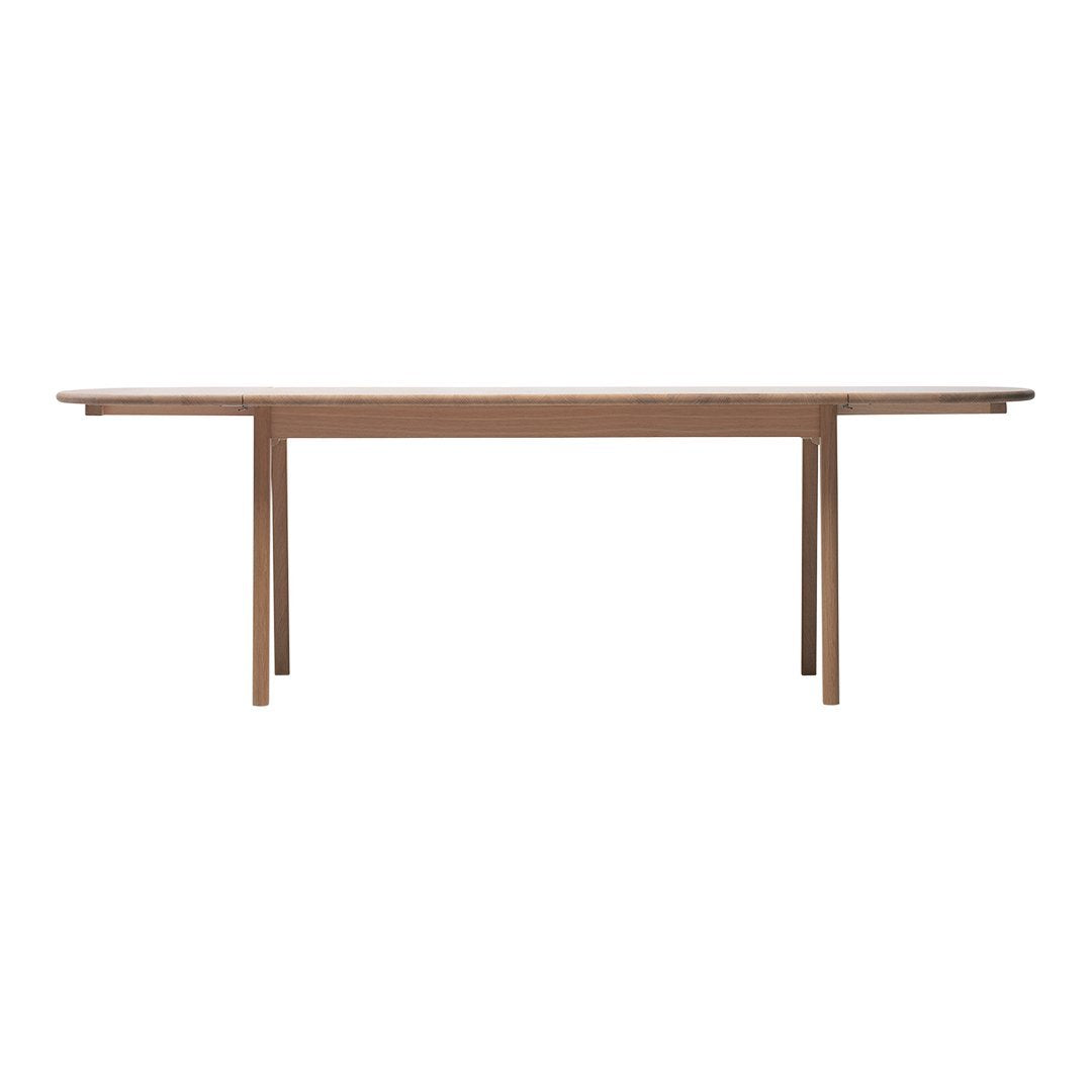 Light wood dining table with a smooth finish and clean, minimalist lines. Ideal for modern interiors.