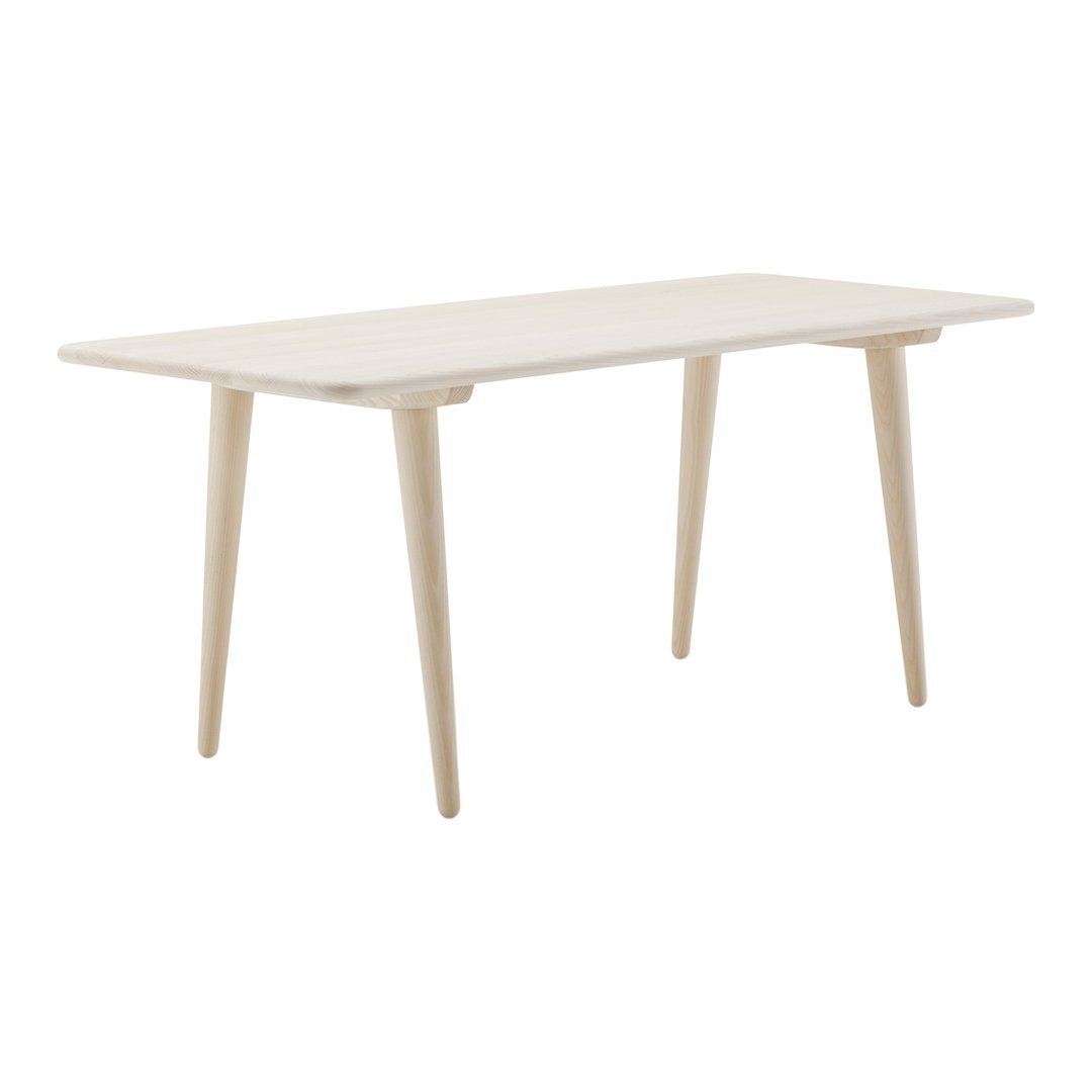 Minimalist white wooden table with light beige legs and a smooth surface, perfect for modern decor.