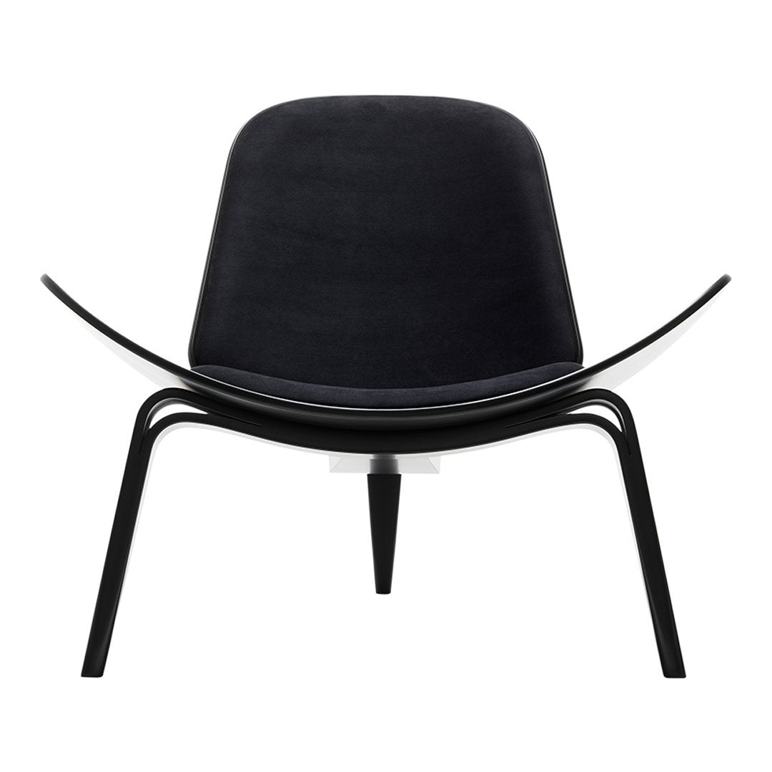 Black designer chair with smooth curves and minimalist black metal legs, showcasing modern elegance.