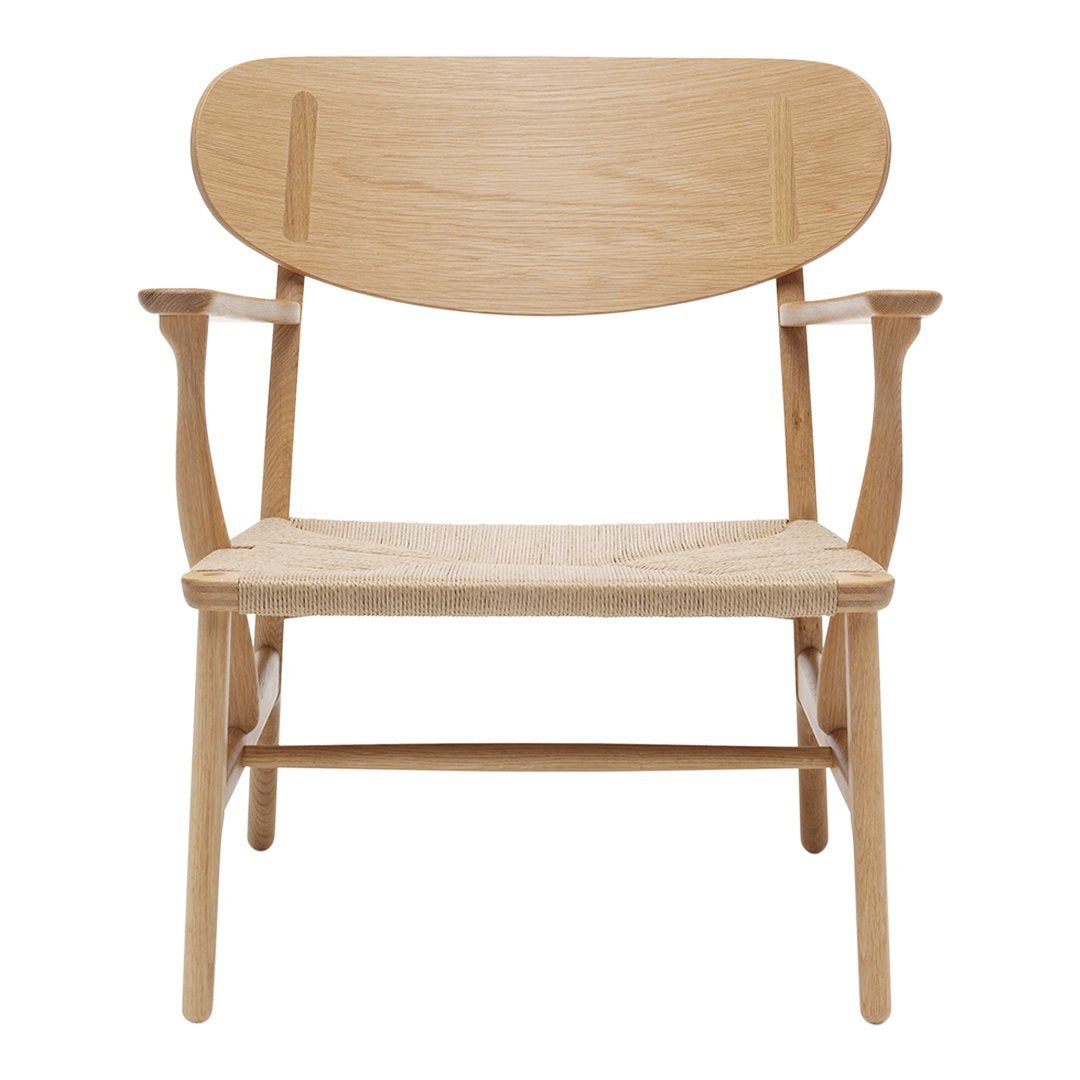 Light oak chair with a natural woven seat and minimalist design, showcasing smooth wood grain and soft curves.