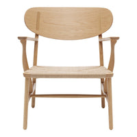 Light oak chair with a natural woven seat and minimalist design, showcasing smooth wood grain and soft curves.