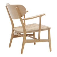 Light oak wooden chair with a minimalist design and natural wood grain pattern, featuring curved backrest and armrests.